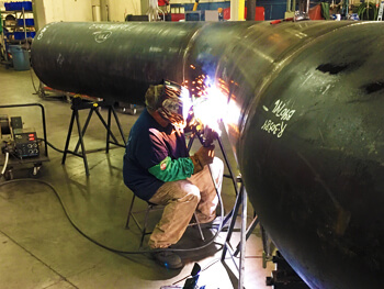 UMEC fabrication team welding a custom project in their fabrication facility