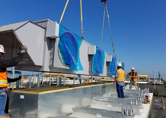UMEC-CA team installing rooftop HVAC equipment